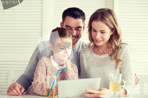 Image of happy family with tablet pc at restaurant