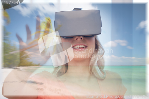 Image of woman with virtual reality headset over beach