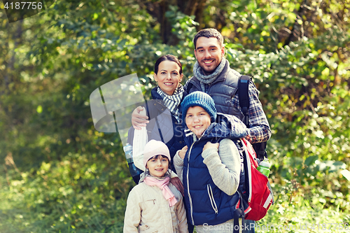 Image of happy family with backpacks hiking