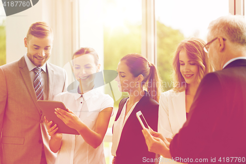 Image of business people with tablet pc computers at office