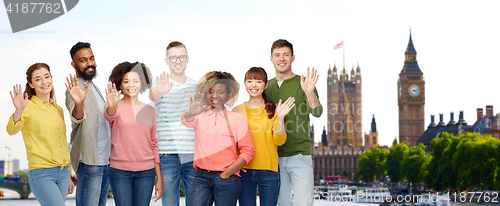 Image of international people waving hand in london