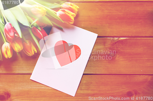 Image of close up of flowers and greeting card with heart