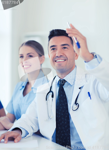 Image of group of happy doctors on conference at hospital