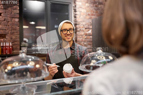 Image of man or barman with coffee cup and customer at cafe