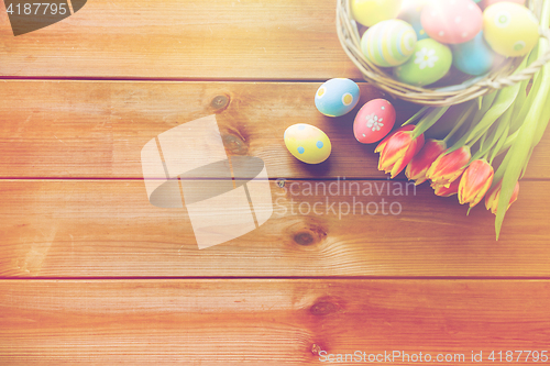 Image of close up of easter eggs in basket and flowers