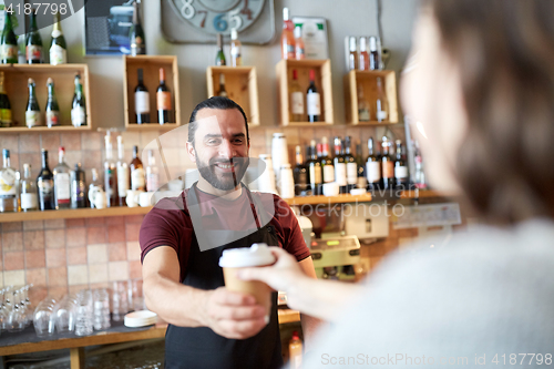 Image of man or waiter serving customer in coffee shop