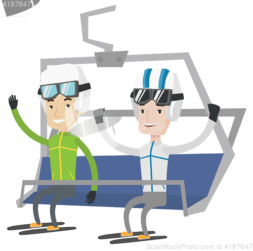 Image of Two happy skiers using cableway at ski resort.