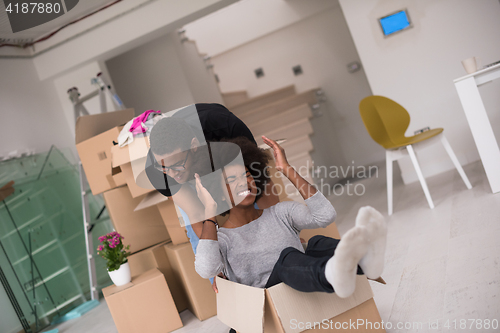 Image of African American couple  playing with packing material