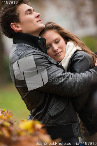 Image of Autumn portrait of attractive happy couple