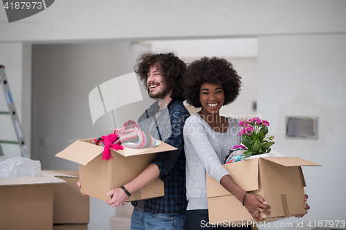 Image of multiethnic couple moving into a new home