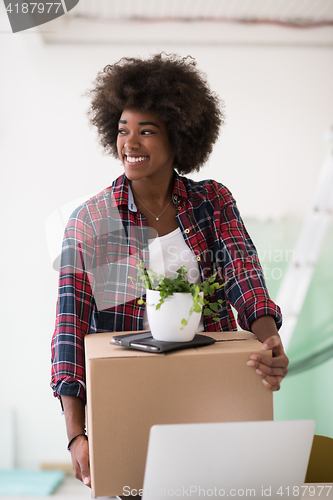 Image of Black girl moving in the new apartment