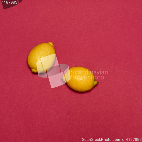 Image of Lemons on red background