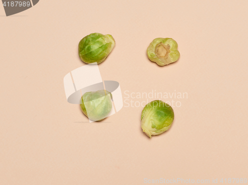 Image of The piles of Brussels sprouts on a pink background