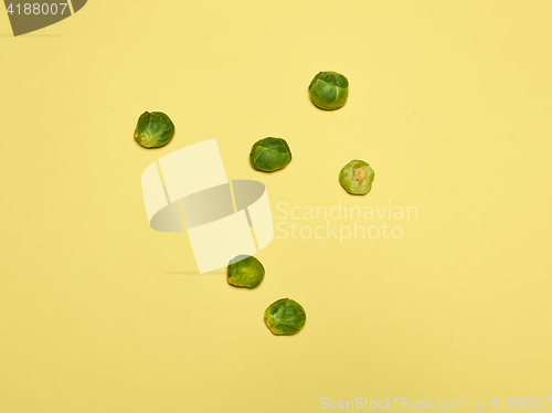 Image of The piles of Brussels sprouts on a yellow background