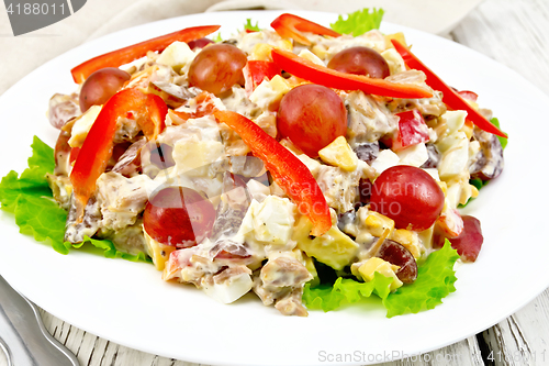 Image of Salad of meat and cheese with grapes on green lettuce