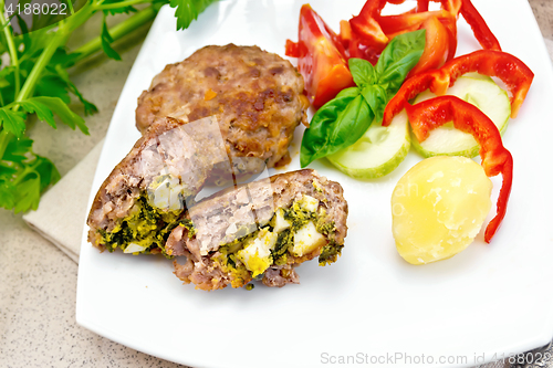 Image of Cutlets stuffed in plate on granite table