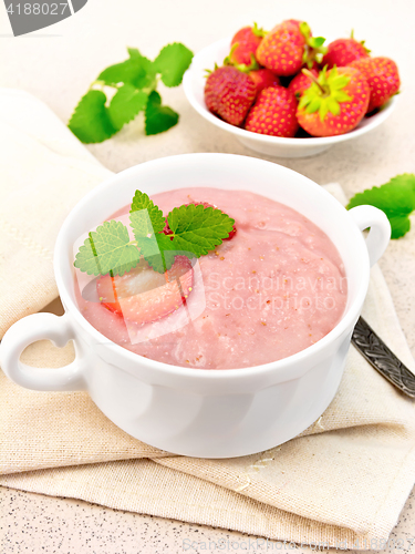 Image of Soup strawberry in white bowl on napkin