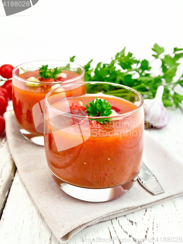 Image of Soup tomato in two glasses with parsley on board