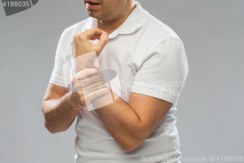 Image of close up of man suffering from pain in hand