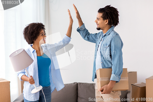 Image of happy couple with stuff moving to new home