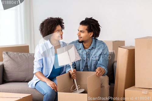 Image of happy couple with stuff moving to new home