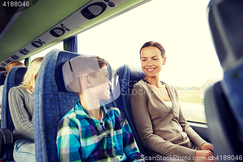 Image of happy family riding in travel bus