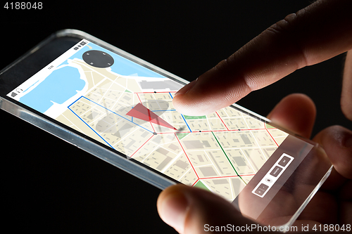 Image of close up of hand with gps map on smartphone