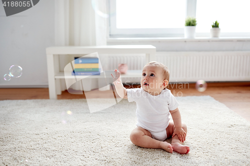 Image of happy baby with soap bubbles at home
