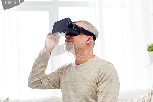 Image of old man in virtual reality headset or 3d glasses