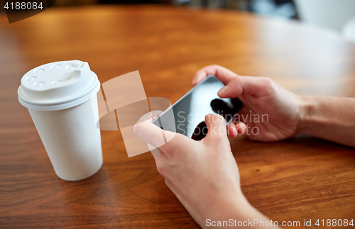 Image of close up of woman with smartphone and coffee