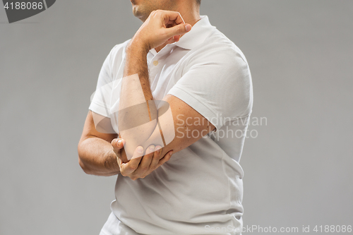 Image of close up of man suffering from pain in hand