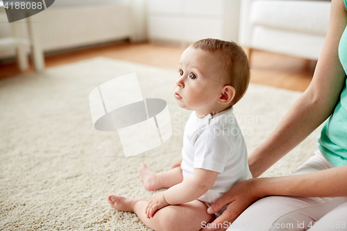 Image of little baby with mother at home