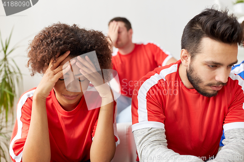 Image of sad friends or football fans at home