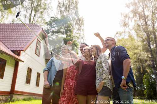 Image of friends taking selfie at party in summer garden