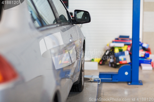 Image of car on lift at repair station