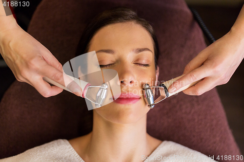 Image of woman having hydradermie facial treatment in spa