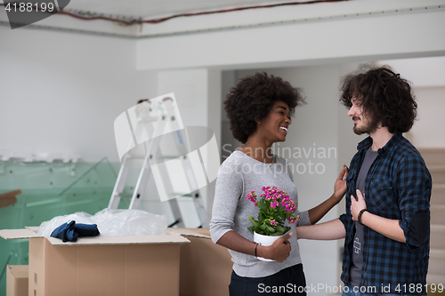 Image of multiethnic couple moving into a new home