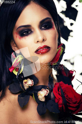 Image of pretty brunette woman with rose jewelry, black and red, bright m