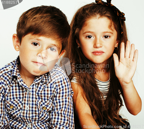 Image of little cute boy and girl hugging playing on white background, ha