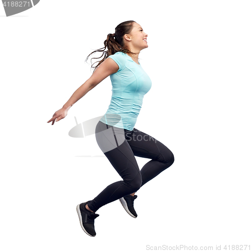 Image of happy smiling sporty young woman jumping in air