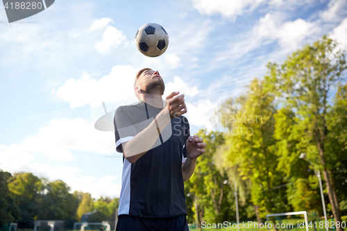 Image of soccer player playing with ball on field