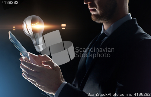 Image of close up of businessman with transparent tablet pc