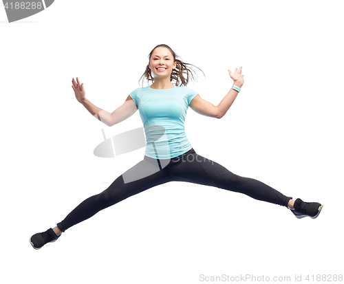 Image of happy smiling sporty young woman jumping in air