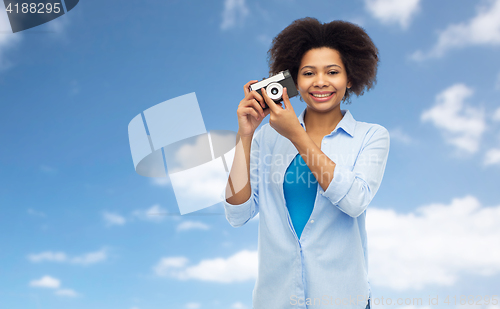 Image of happy african american woman with film camera