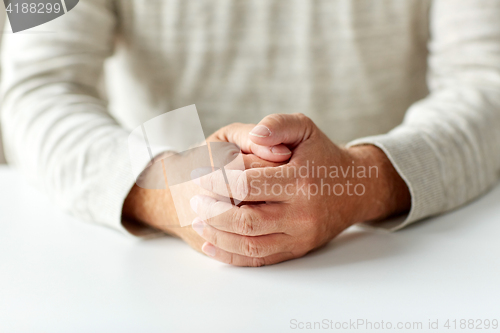 Image of close up of senior man hands on table