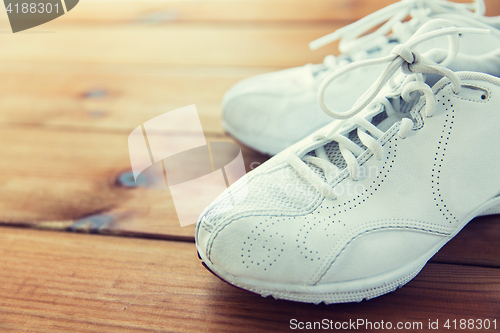 Image of close up of sneakers on wooden floor