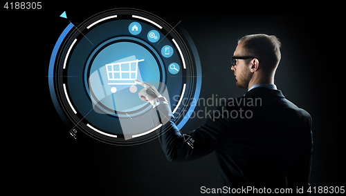 Image of businessman pointing finger to shopping cart