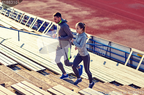 Image of couple running upstairs on stadium