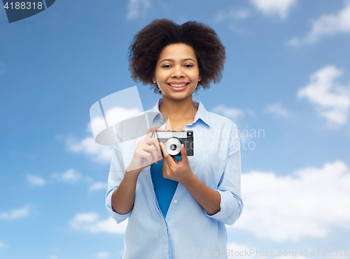 Image of happy african american woman with film camera