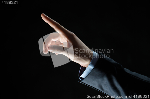 Image of close up of hand pointing finger to something